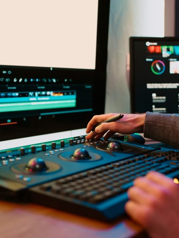 Male Video Editor Working on His Personal Computer with Big blank Display